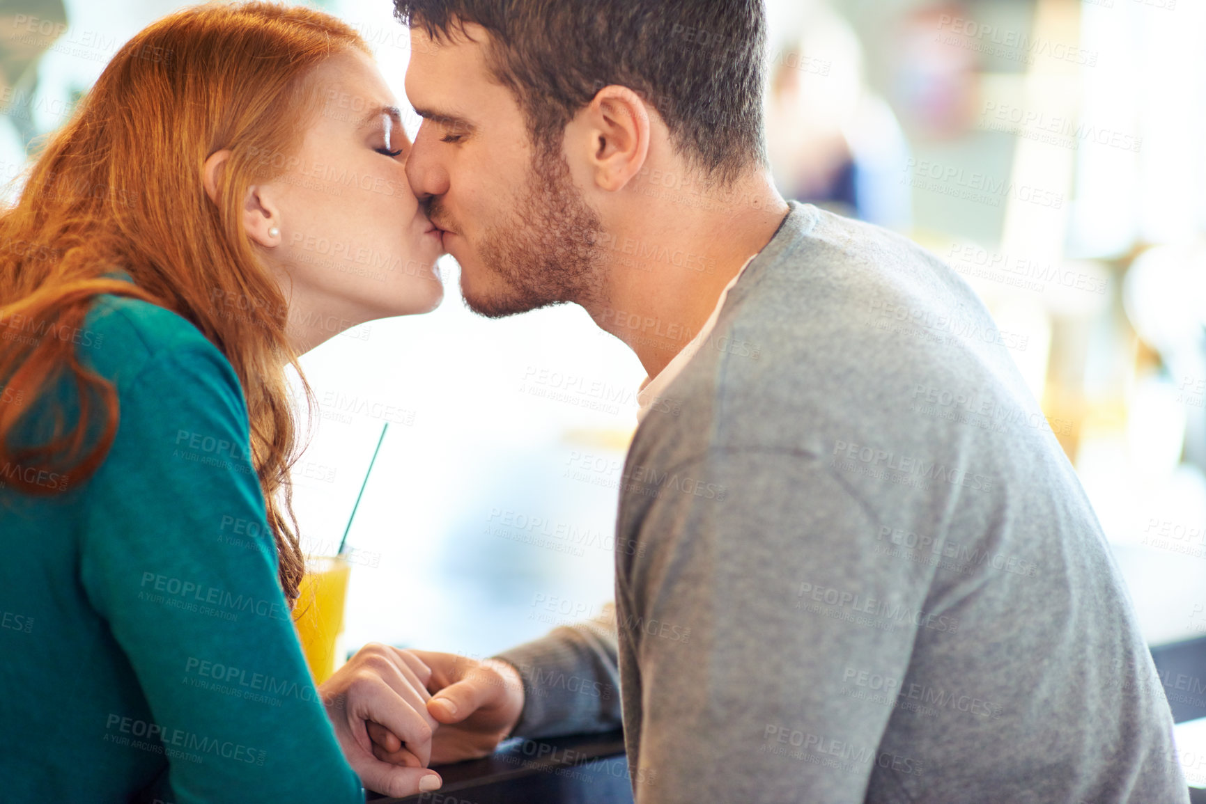 Buy stock photo Couple, date and kiss with romance, coffee shop or restaurant with happiness together. Man, woman and love for relationship, care and smile for flirting on break for relax or bonding in cafe
