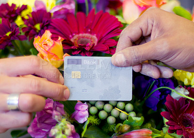 Buy stock photo Cropped shot of a woman buying flowers with her credit card from a florist