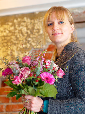 Buy stock photo Portrait of a young woman holding a pretty bunch of flowers