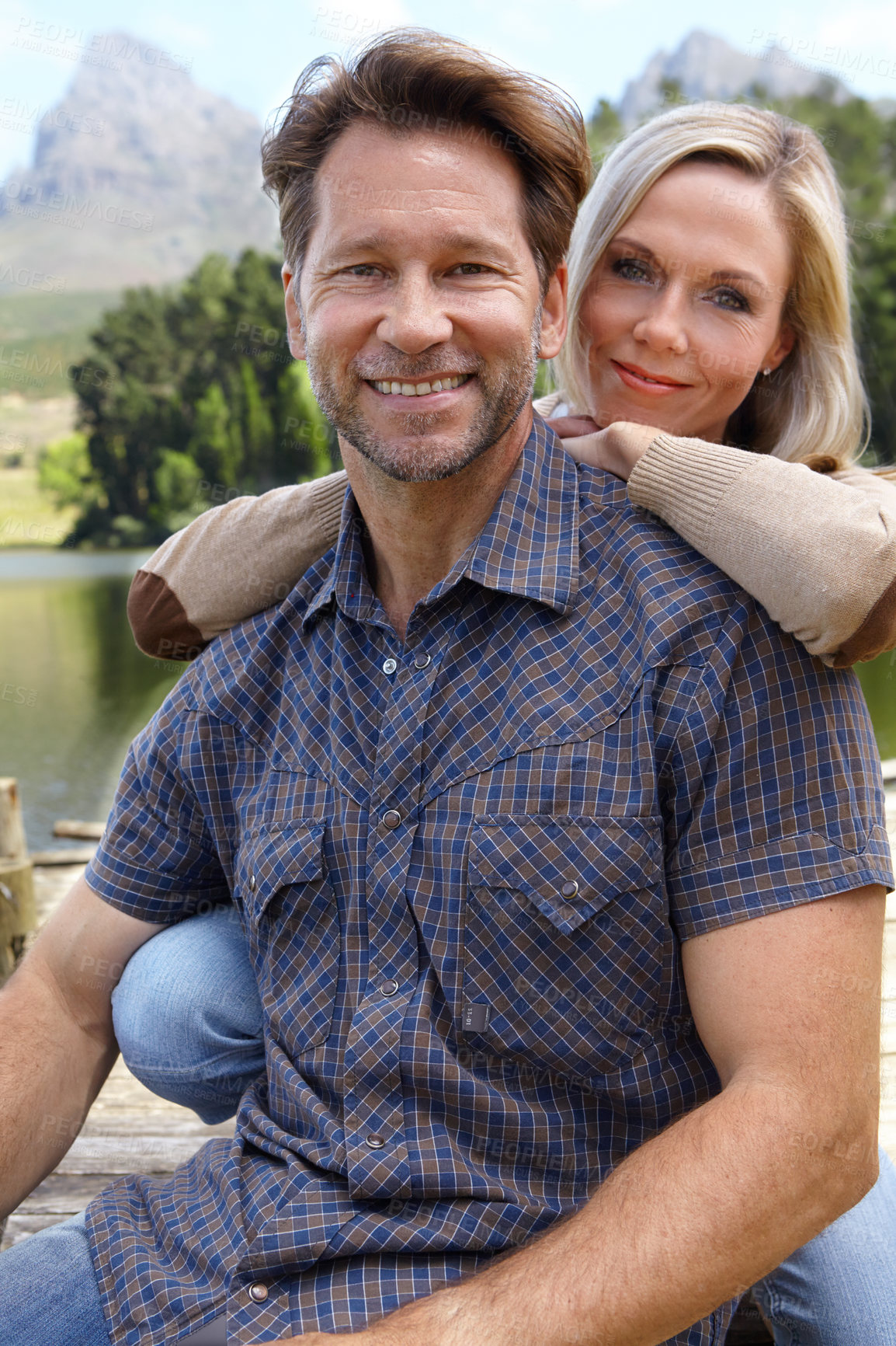 Buy stock photo Smile, love and portrait of couple at countryside in summer for vacation, holiday and bonding together. Man, woman and trees with lake for weekend adventure, travel and tourism outdoors in Europe