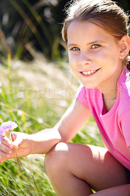 Buy stock photo Girl, grass and portrait of kid with flower in nature for spring enjoyment, vacation and development. Happy, child and relax with plant in meadow for peace, holiday and adventure in green park
