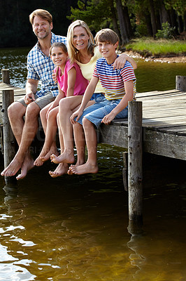 Buy stock photo Parents, lake and kids on pier for portrait, hug and happy on vacation, relax or love in summer sunshine. Mom, dad and children with smile, care or bonding with family by river on holiday in Colorado