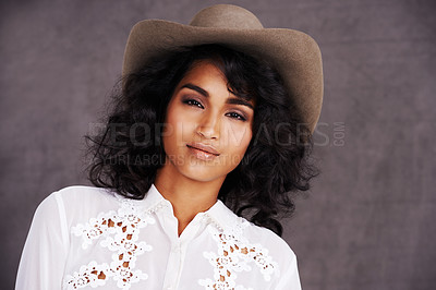 Buy stock photo Portrait, studio and woman with cowgirl fashion, confidence  and relax with girl in stetson hat. Rodeo, western style and face Mexican model with cowboy culture, wild west clothes and grey background