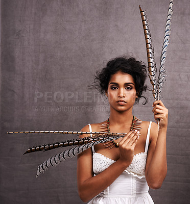 Buy stock photo Fashion, studio and portrait of boho woman with feather, mockup and modern Native American style. Creative, culture and girl with indigenous aesthetic, serious or unique face on grey background space