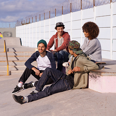 Buy stock photo Skate park, diversity and group with conversation, sunshine and relaxing after training for competition. Multiracial, friends and team on a break, summer and bonding together with skaters in a park