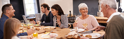 Buy stock photo Shot of a family sitting down to dinner