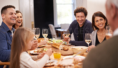 Buy stock photo Happy, conversation and family at dinner in dining room for party, celebration or event at modern home. Smile, bonding and group of people enjoying meal, supper or lunch together with wine at house.