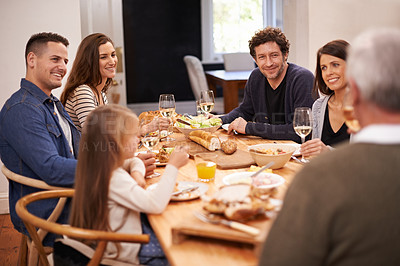 Buy stock photo Smile, conversation and family at dinner in dining room for party, celebration or event at modern home. Happy, bonding and people enjoying meal, supper or lunch together with wine for toast at house.