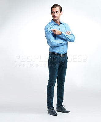 Buy stock photo Shot of a handsome young man pointing off camera