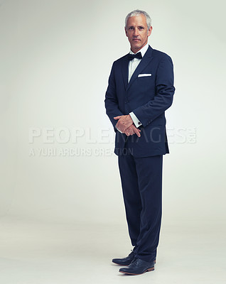 Buy stock photo A full length studio portrait of a handsome mature man in a pinstripe suit