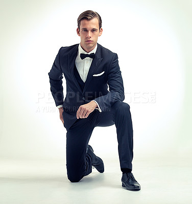 Buy stock photo A studio portrait of a handsome young man in a vintage pinstripe suit kneeling