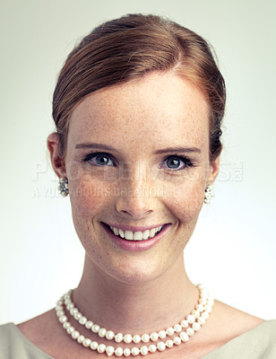 Buy stock photo Portrait, fashion and beauty of happy woman in studio with vintage pearl necklace isolated on a gray background. Face, freckles and skin of young person with smile, style and elegance in Ireland