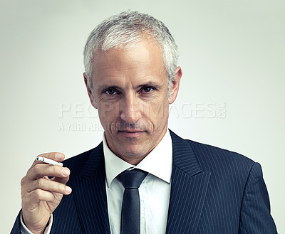 Buy stock photo Portrait, suit and mature man smoking cigarette with salesman in studio isolated on a gray background. Face, fashion and serious businessman with tobacco, ceo or  manager in vintage clothes in Canada
