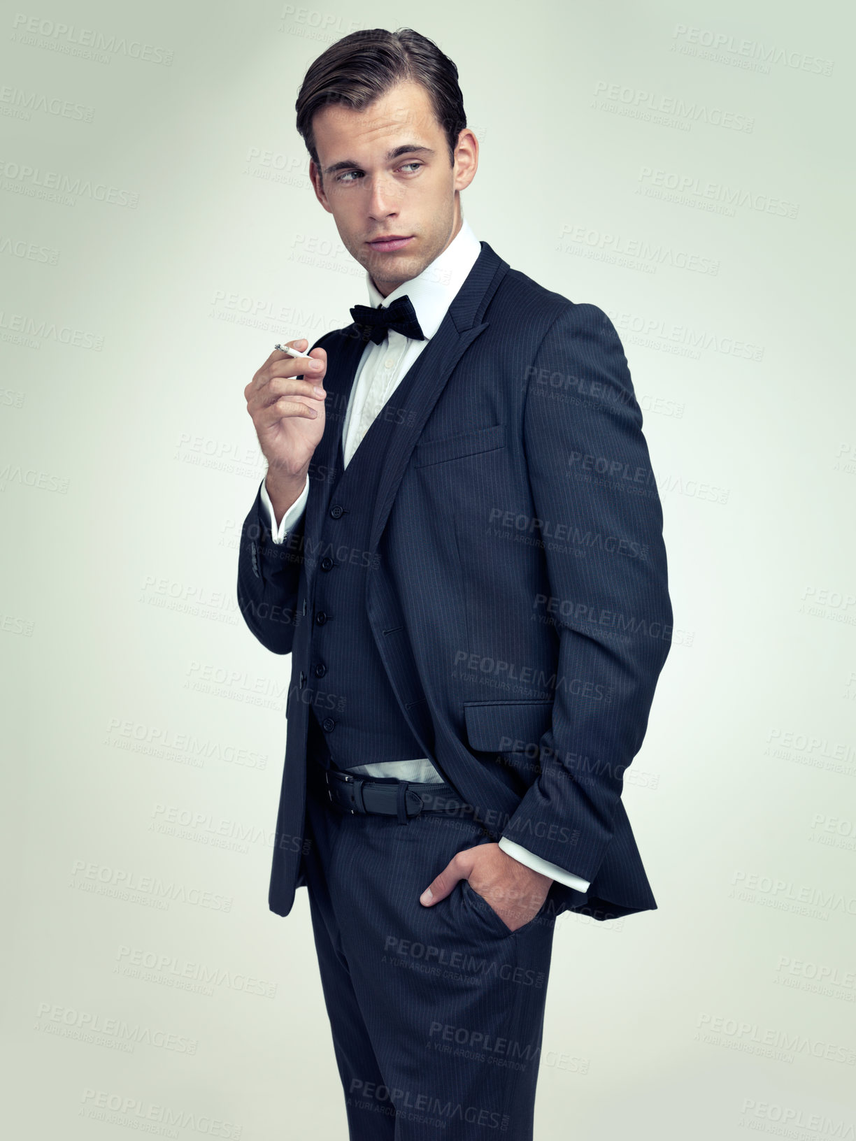 Buy stock photo Fashion, gentleman and tuxedo with cigarette in studio for stylish, trend and habit with suit and luxury. Young person and stare with confidence for vintage, wealthy and handsome for old fashioned 