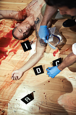 Buy stock photo Shot of an investigator attending a bloody crime scene