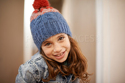 Buy stock photo Girl, portrait and child with fashion in winter at home with pride and confidence in clothes with beanie. Kid, smile or relax in house with hat, jacket or casual style on holiday or vacation