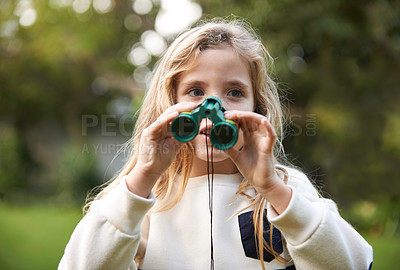 Buy stock photo An adorable young child holding binoculars outdoors