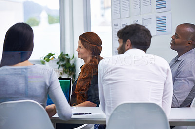 Buy stock photo A group of businesspeople having a meeting in a boardroom at work