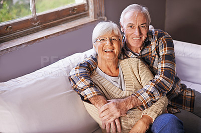 Buy stock photo Senior couple, hug and portrait on couch with smile, love and connection in living room for retirement. Elderly woman, old man and embrace on sofa in lounge with pride, care and happy in apartment