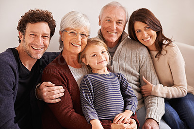 Buy stock photo A cropped portrait of a happy multi-generation family sitting together on a sofa