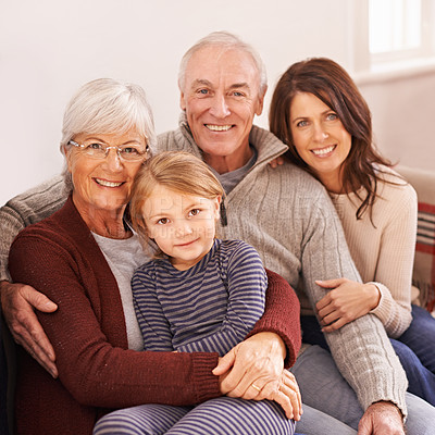 Buy stock photo A cropped portrait of a happy multi-generation family sitting together on a sofa