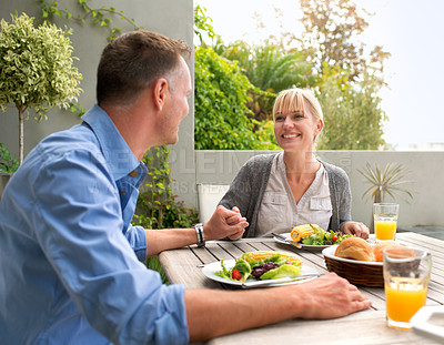 Buy stock photo A cropped shot of a happy couple sharing a delicious vegetarian meal together