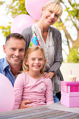 Buy stock photo Portrait, family or gift at happy birthday, party or balloon as love, bonding or together outside. Papa, mama or girl as smile at box, hug or celebration of gratitude, congratulations or childhood