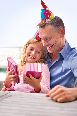Buy stock photo A cropped shot of a happy man giving his young daughter a gift on her birthday