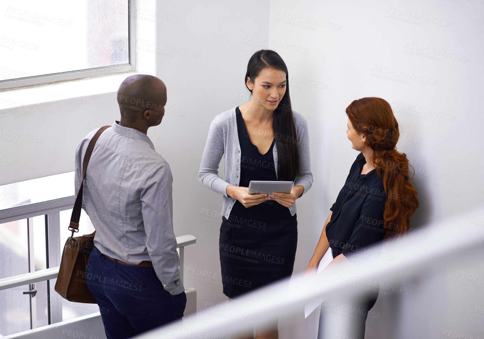 Buy stock photo Colleagues, communication and teamwork in stairwell, talking and corporate employees. Talking, tablet and team or coworkers during break, technology and discussion and feedback on workplace stairs