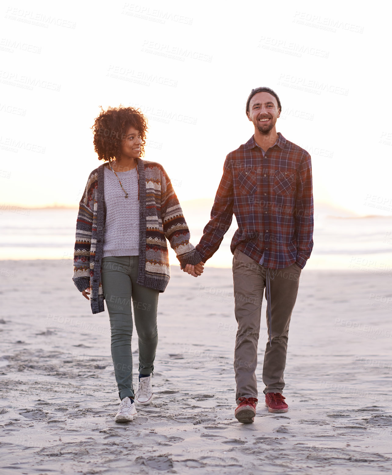 Buy stock photo Couple, smile and walking together on beach, happy calm people on vacation. Ocean, outdoor and partners in love with respect and care, date and romantic stroll for relax with seaside sunrise