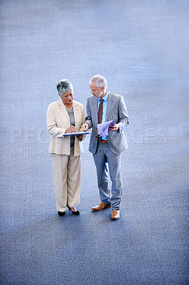 Buy stock photo Professional, businesspeople talking and documents, signing for work with coworkers. Mature, business man and woman discussing information, lawyers for corporate company staff standing together
