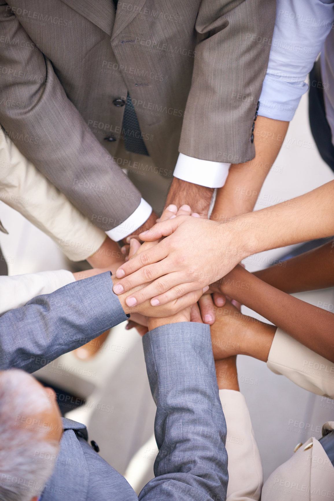 Buy stock photo Shot of a group of coworkers with their hands in a huddle