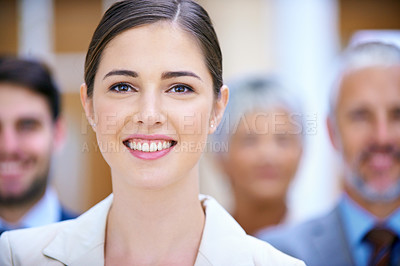 Buy stock photo Portrait of a successful businesswoman standing in front of her colleagues