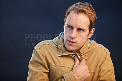 Buy stock photo Thinking, fashion and man with jacket for winter, cold weather and planning a holiday or vacation. Warm, coat and person with ideas for protection from freezing wind on dark background in studio 