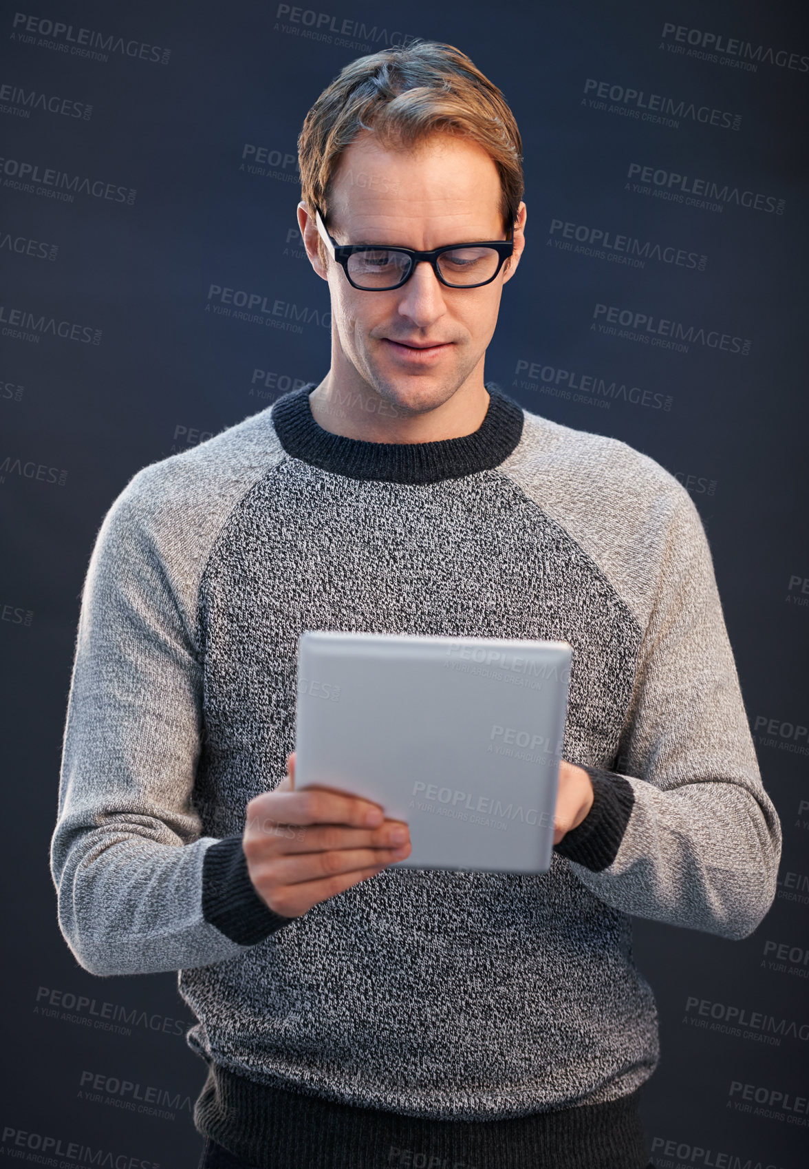 Buy stock photo Man, glasses and tablet for reading in studio with connection, contact and fashion by dark background. Person, entrepreneur and digital touchscreen, pride and confidence with app for social network