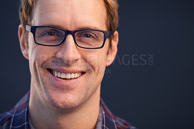 Buy stock photo Man, glasses and smile in studio portrait with pride, closeup and confidence by dark background. Person, model and happy with spectacles for healthy vision, eyesight and shirt for fashion with style