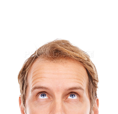 Buy stock photo Cropped shot of the upper half of a young man's face looking up at copyspace