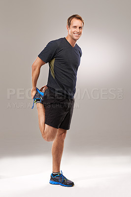 Buy stock photo Portrait, man or stretching as flexibility, mobility or exercise for wellness, workout or training. Happy, runner or athletic male person as strong, proud or muscle care in studio on grey background