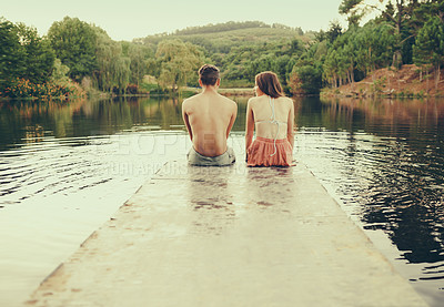 Buy stock photo Lake, date and man relax with woman in summer, holiday or vacation in nature with dock on water. People, sitting and enjoy outdoor environment at river or dam with landscape of forest or woods