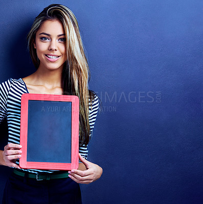 Buy stock photo Woman, chalkboard and mockup space in studio portrait with smile, education and promotion by blue background. Teacher, model or person with frame, board and happy for feedback, choice and advertising