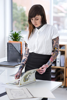 Buy stock photo Tattoo, woman and document in office for business with creative planning, design choice and sketch in folder. Entrepreneur, artist or ring binder with inspiration for body art or work project at desk