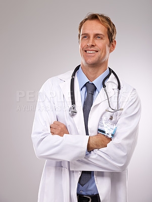 Buy stock photo Man, doctor and thinking on healthcare in studio, medical expert and specialist on gray background. Male person, cardiologist and proud of choice or decision on medicare, planning and idea for health