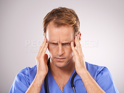 Buy stock photo Doctor, studio and headache for stress, worry or tension and stethoscope for job. Man, worry or migraine for professional, medic and health care or medical pressure and overworked on white background