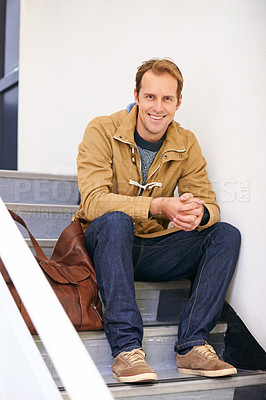 Buy stock photo Portrait of a young man sitting in a stairwell