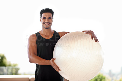 Buy stock photo Portrait of a handsome man standing with an exercise ball