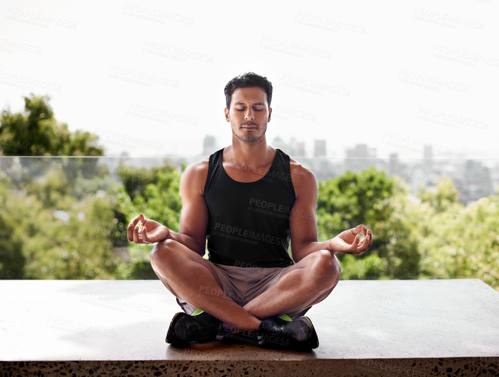 Buy stock photo Full length shot of a man meditating in the lotus position