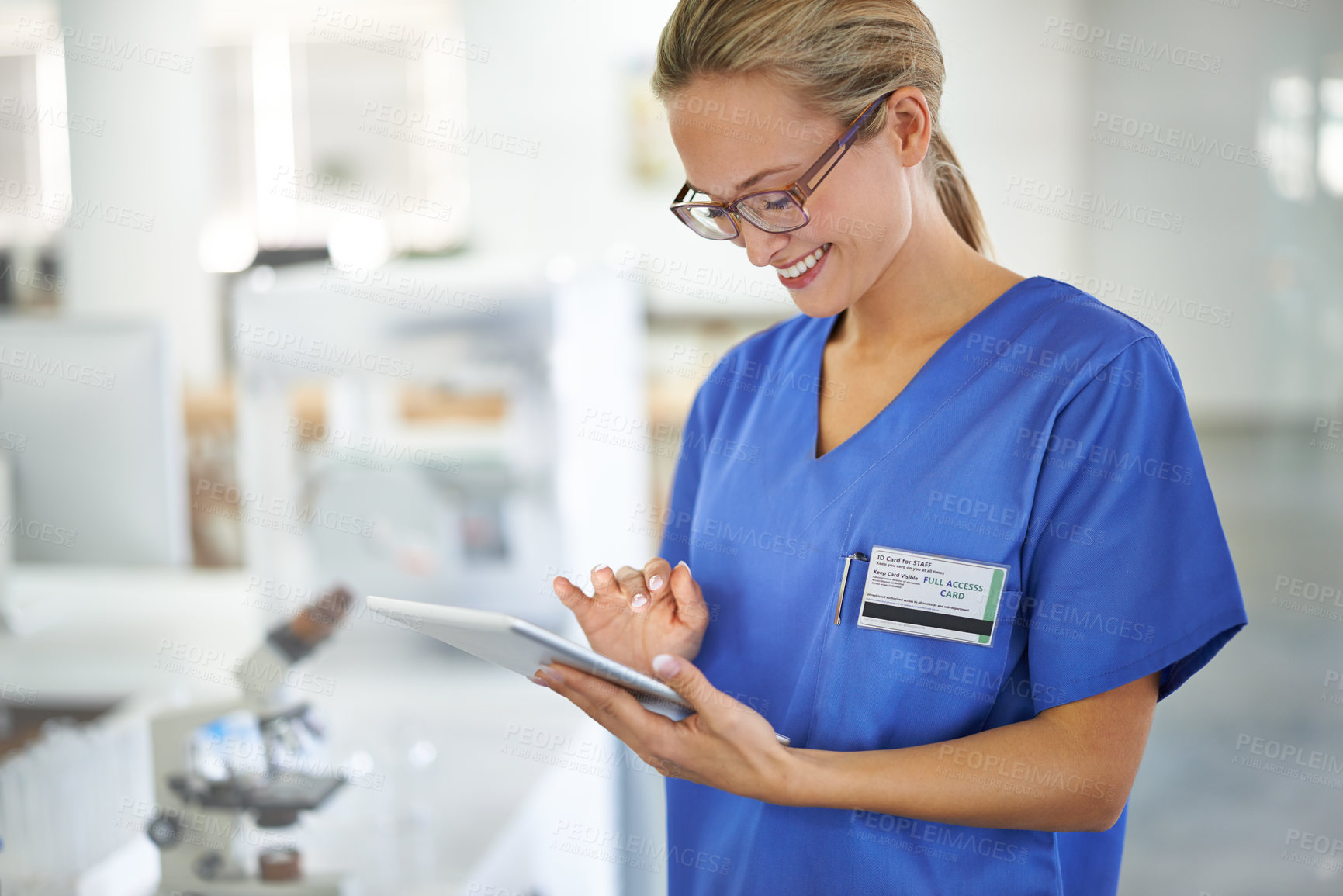 Buy stock photo A beautiful female doctor holding a tablet while standing in a lab