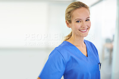 Buy stock photo Portrait of a confident young doctor wearing blue scrubs