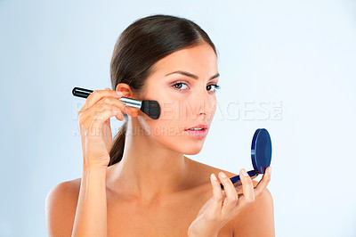 Buy stock photo Portrait, woman and makeup with brush and compact for foundation or blush with beauty on blue background. Powder, cosmetics and product for cosmetology with tools, skin glow and facial in studio