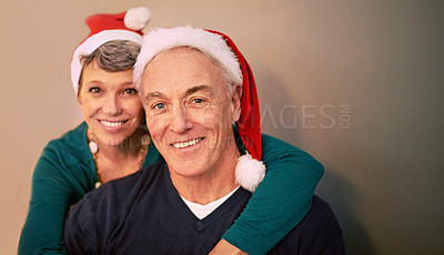 Buy stock photo Christmas, portrait and senior couple with love, holiday and support together in home with romance. Happy, retirement and marriage with smile and hug in house with celebration and santa hat with joy